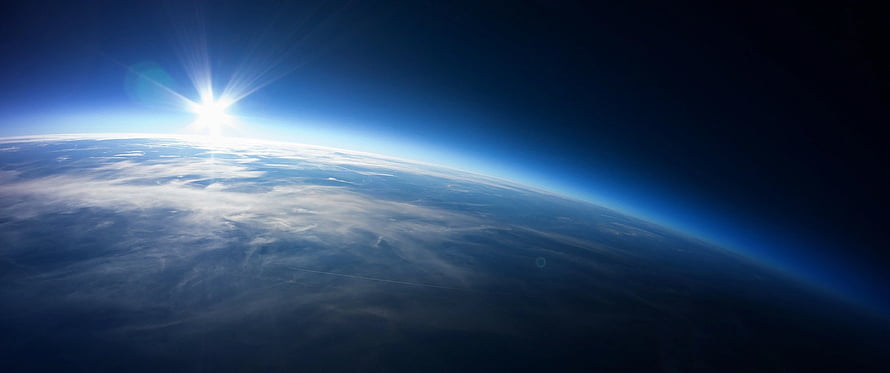 Sunrise Over Earth From Space With Blue Atmosphere And Clouds HD wallpaper