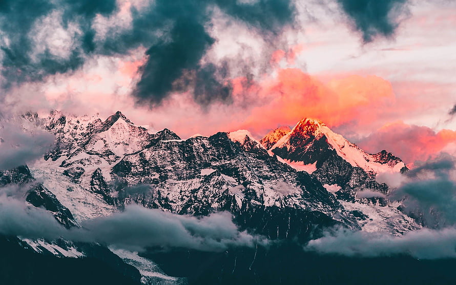 Snow-Capped Mountain Peaks Bathed in Pink Sunset Light with Dramatic Clouds HD wallpaper