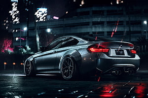 Sleek BMW M4 Coupe Parked on Wet City Street at Night with Neon Lights HD wallpaper