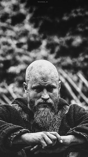 Ragnar Lothbrok from Vikings in a moody black and white portrait with a stern expression and weathered beard HD phone wallpaper