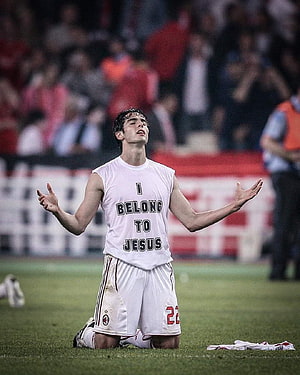 Kaka kneeling on soccer pitch wearing I belong to Jesus shirt HD phone wallpaper