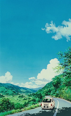 Vintage Car Driving on Winding Road Through Green Mountains Under Blue Sky HD phone wallpaper