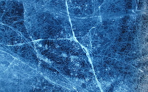 Deep Blue Frozen Ice Surface with Intricate Crack Patterns and Frost Textures HD wallpaper