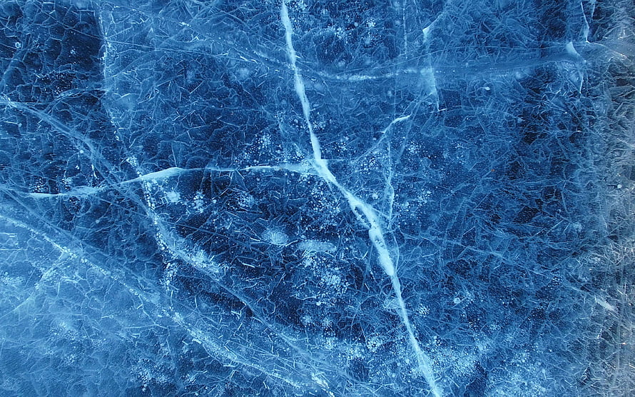 Deep Blue Frozen Ice Surface with Intricate Crack Patterns and Frost Textures HD wallpaper
