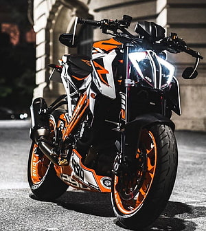 KTM RC 390 motorcycle with orange and white racing livery parked on street at night HD phone wallpaper