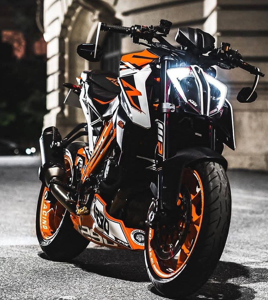 KTM RC 390 motorcycle with orange and white racing livery parked on street at night HD phone wallpaper