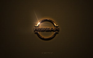 Nissan Golden Emblem on Textured Brown Metal Surface with Dramatic Lens Flare HD wallpaper