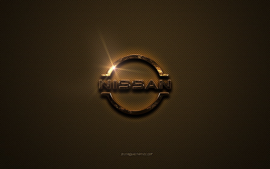 Nissan Golden Emblem on Textured Brown Metal Surface with Dramatic Lens Flare HD wallpaper