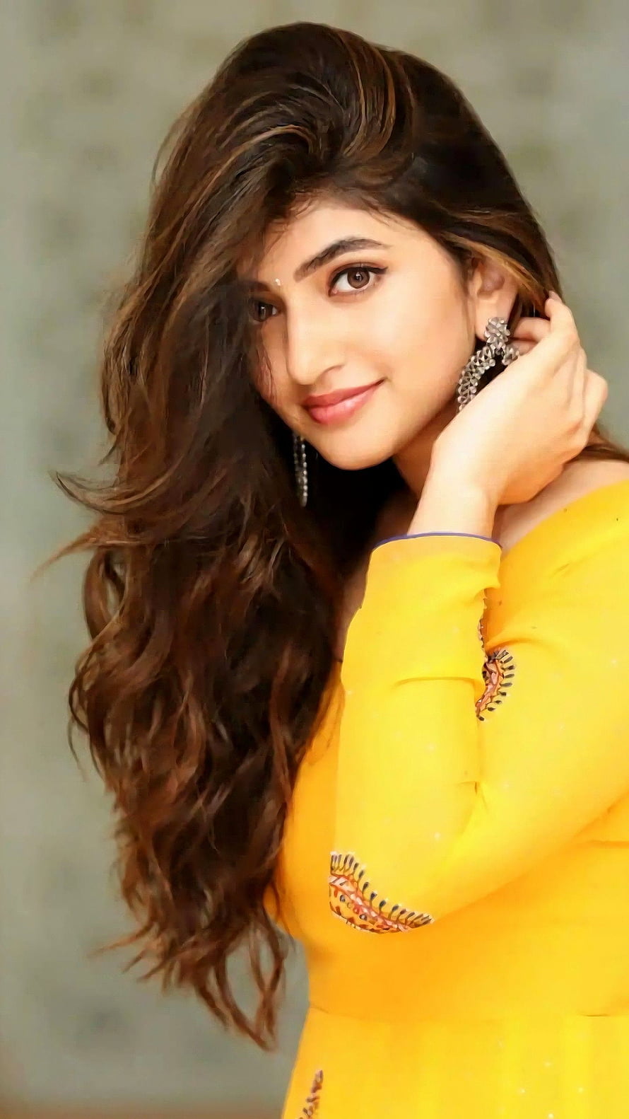 Pooja Hegde in a vibrant yellow traditional outfit with intricate embroidery and elegant jewelry HD phone wallpaper