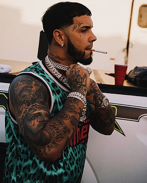 Anuel AA in a green leopard print jersey with diamond chains and full sleeve tattoos HD phone wallpaper