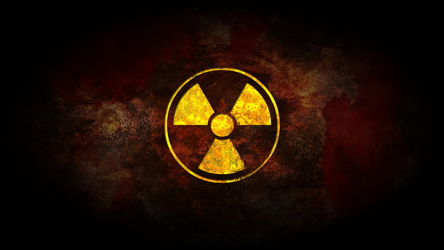 Glowing Yellow Radiation Symbol on Dark Grunge Background HD wallpaper