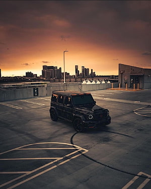 Black Brabus G700 SUV Parked on Rooftop at Sunset with City Skyline HD phone wallpaper