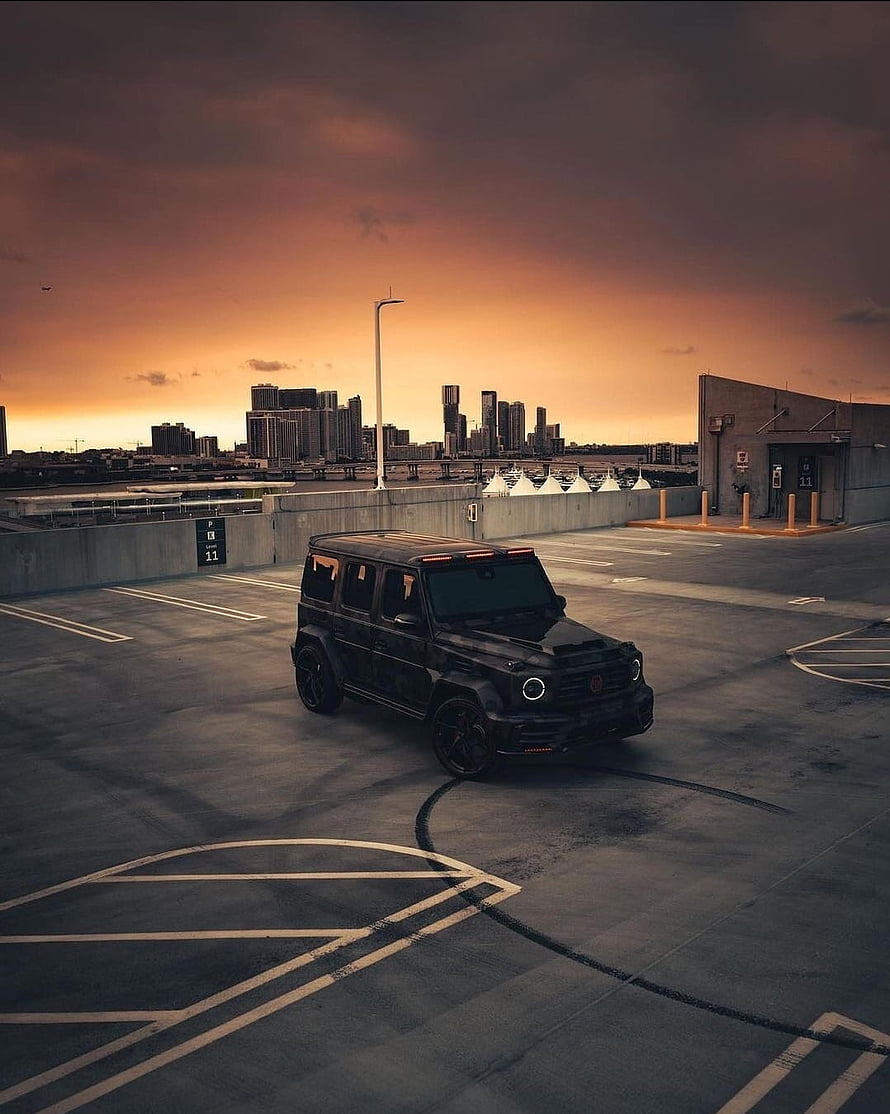 Black Brabus G700 SUV Parked on Rooftop at Sunset with City Skyline HD phone wallpaper