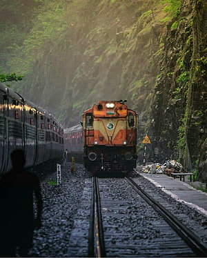 Indian Railways locomotive navigating a misty mountain pass with lush green cliffs HD phone wallpaper