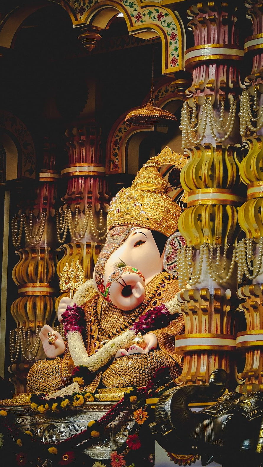 Ornate Golden Ganesha Statue in Temple with Pearl Garlands HD phone wallpaper