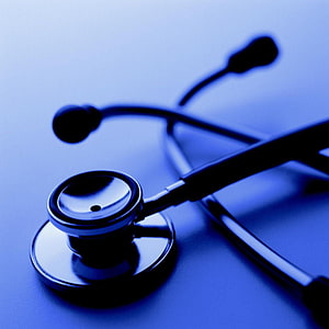 Close-Up of a Medical Stethoscope on a Blue Background HD phone wallpaper