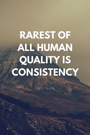 Motivational Quote on Consistency Over a Misty Mountain Landscape HD phone wallpaper