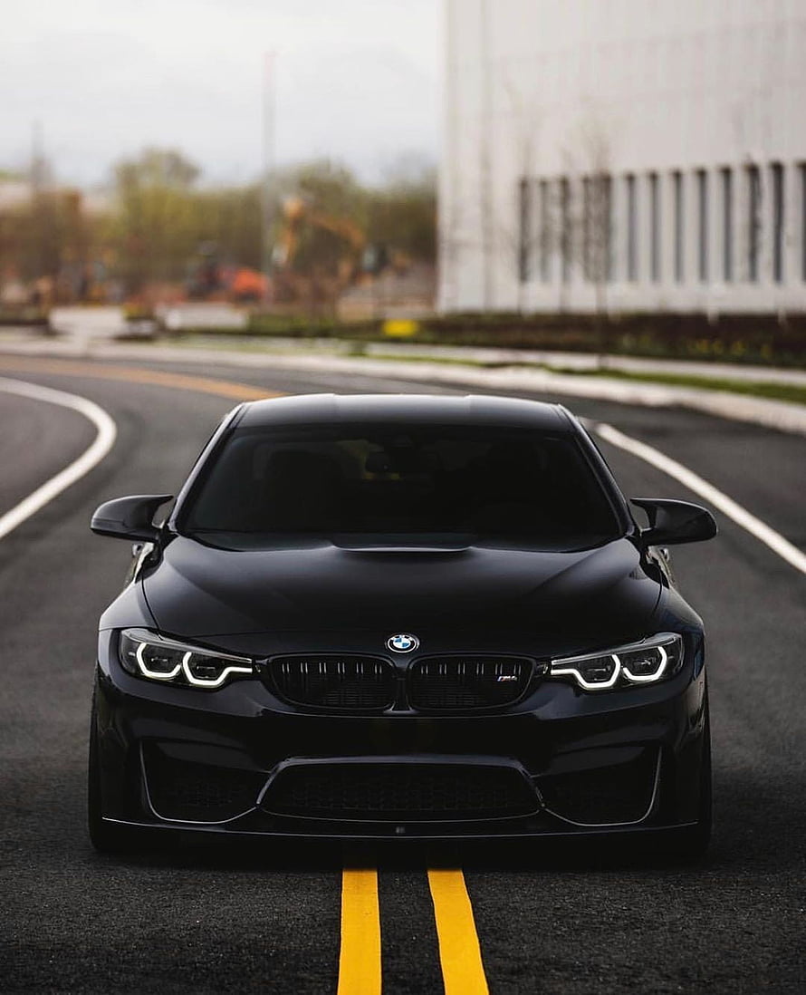 Black BMW M4 Competition Front View on Asphalt Road HD phone wallpaper
