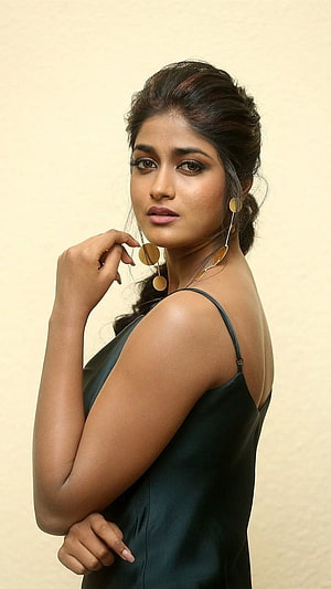 Portrait of Indian actress Keerthy Suresh wearing a black dress and gold earrings HD phone wallpaper