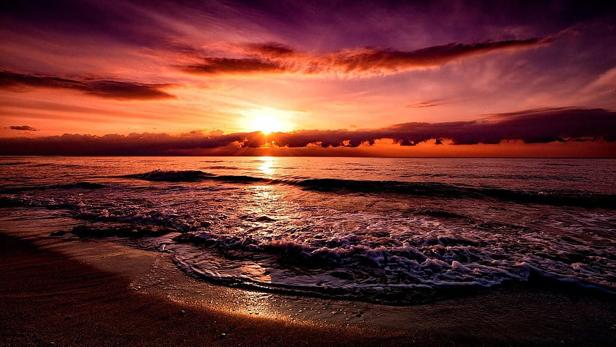 Vibrant Sunset Over Ocean Waves With Purple And Orange Sky HD wallpaper