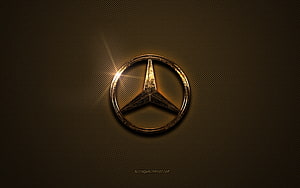 Golden Mercedes-Benz Logo on Dark Textured Background HD wallpaper