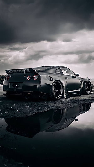 Matte Black Nissan R35 GT-R Widebody Stance Under Dramatic Stormy Sky HD phone wallpaper