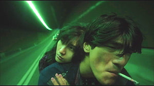 Wong Kar Wai cinematic still of a couple in a green-lit tunnel with a cigarette HD wallpaper