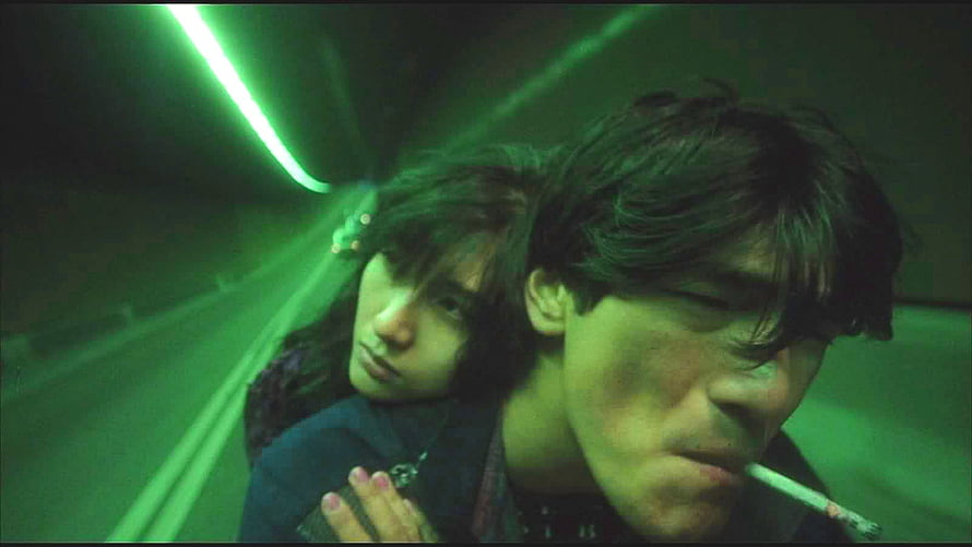 Wong Kar Wai cinematic still of a couple in a green-lit tunnel with a cigarette HD wallpaper