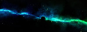 Vibrant Blue and Green Nebula Spanning a Dark Dual Monitor Space Scene HD wallpaper