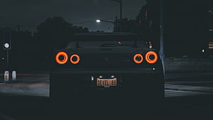 Nissan Skyline GT-R R34 Rear View at Night with Glowing Orange Taillights HD wallpaper
