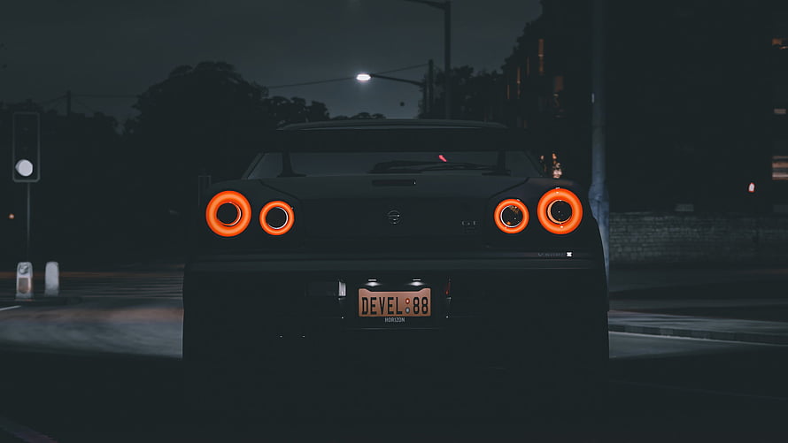 Nissan Skyline GT-R R34 Rear View at Night with Glowing Orange Taillights HD wallpaper