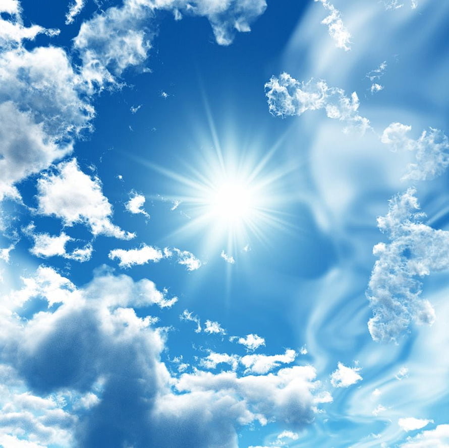Bright Sunburst in a Blue Sky with Fluffy White Clouds and Radiant Light Rays HD wallpaper