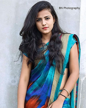 Vaishnavi Chaitanya in a vibrant teal and blue sari with a gold border HD phone wallpaper