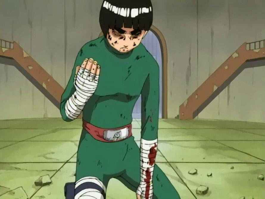 Rock Lee from Naruto kneeling in a damaged arena with bandaged arms and a determined expression HD wallpaper
