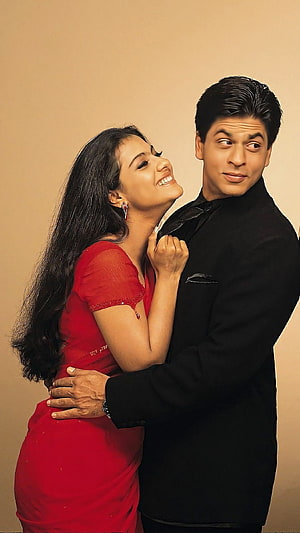 Shah Rukh Khan and Kajol in a playful romantic pose from the Bollywood film Kuch Kuch Hota Hai HD phone wallpaper