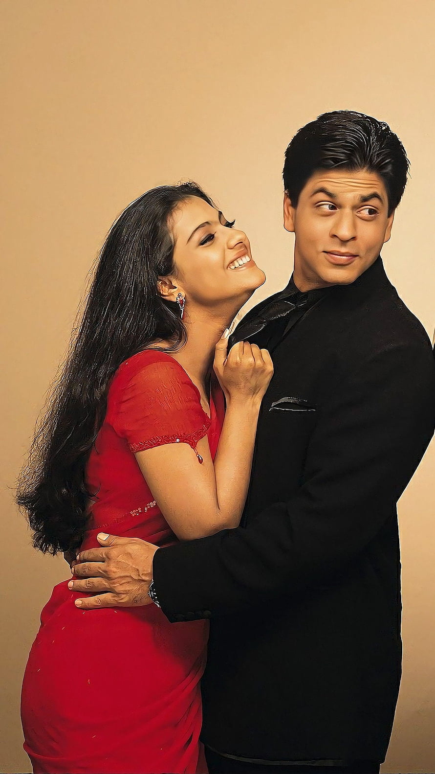 Shah Rukh Khan and Kajol in a playful romantic pose from the Bollywood film Kuch Kuch Hota Hai HD phone wallpaper