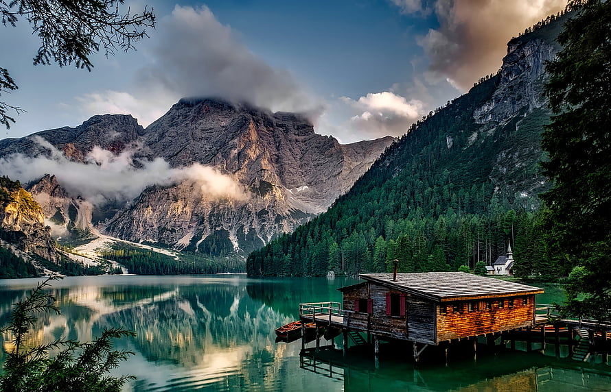 Serene Alpine Lake with Wooden Boathouse and Majestic Mountain Reflections HD wallpaper