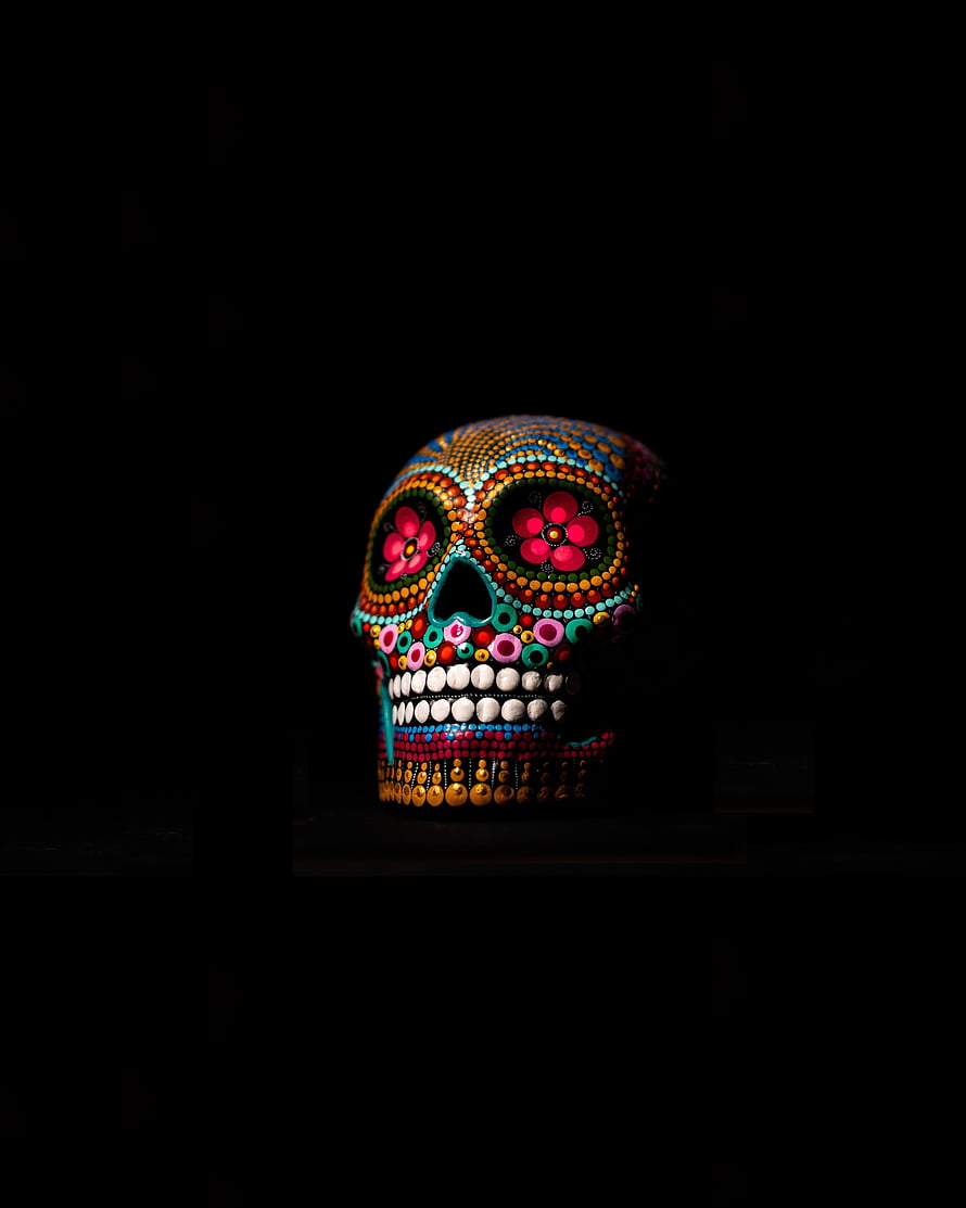 Vibrant Beaded Sugar Skull with Floral Eye Patterns on Black Background HD phone wallpaper