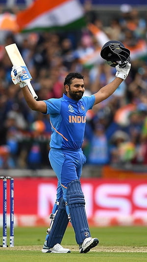 Rohit Sharma Celebrating a Milestone in India Cricket Kit on the Field HD phone wallpaper