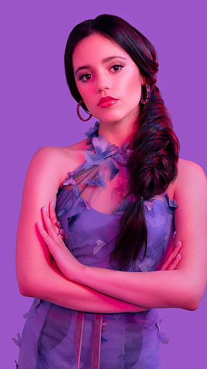 Jenna Ortega in a purple floral dress with a side braid against a purple background HD phone wallpaper