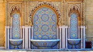 Traditional Moroccan Zellige Fountain with Intricate Carved Stucco and Geometric Tilework HD wallpaper