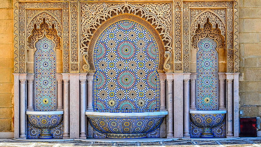 Traditional Moroccan Zellige Fountain with Intricate Carved Stucco and Geometric Tilework HD wallpaper