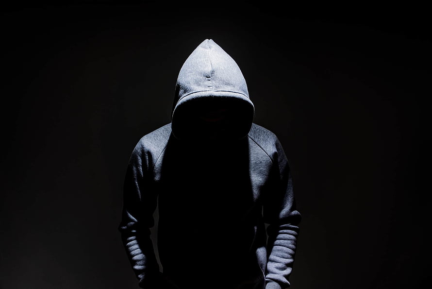 Mysterious Hooded Figure in Dramatic Shadow HD wallpaper