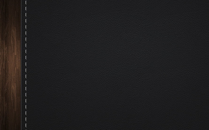 Dark Leather Notebook Cover with White Stitching on Wooden Surface HD wallpaper