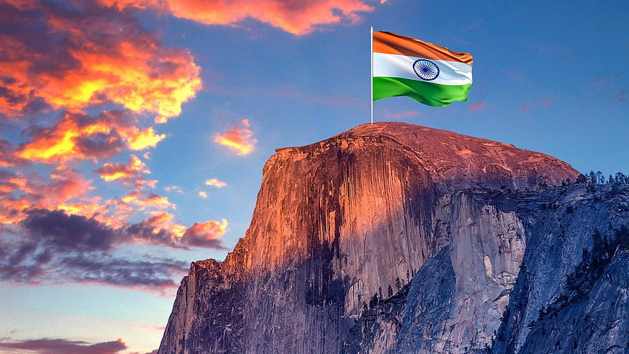 Indian National Flag Flying Above a Granite Mountain Peak at Sunset HD wallpaper