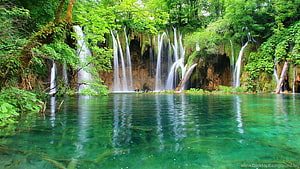 Crystal Clear Turquoise Waterfall Cascading Into A Serene Forest Lake HD wallpaper