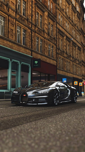Sleek Black Bugatti Chiron Parked on Urban Street with Brick Architecture HD phone wallpaper