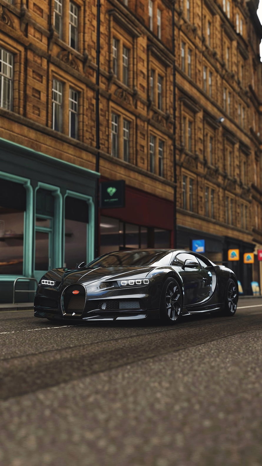 Sleek Black Bugatti Chiron Parked on Urban Street with Brick Architecture HD phone wallpaper