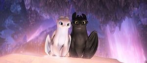 Toothless and Light Fury Baby Dragons Sitting Together in a Crystal Cave HD wallpaper