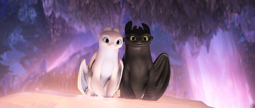 Toothless and Light Fury Baby Dragons Sitting Together in a Crystal Cave HD wallpaper